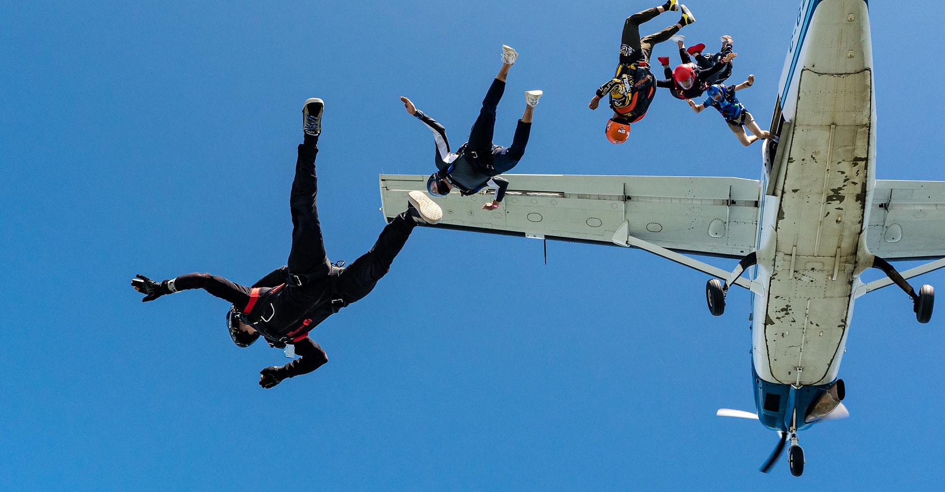Skydivers jumping from a plane at 15,250 feet